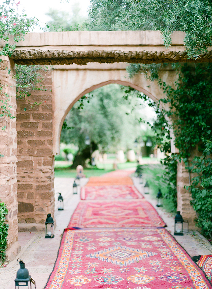 Rug-lined pathway in Marrakech, Morocco by photographer, Laura Ivanova