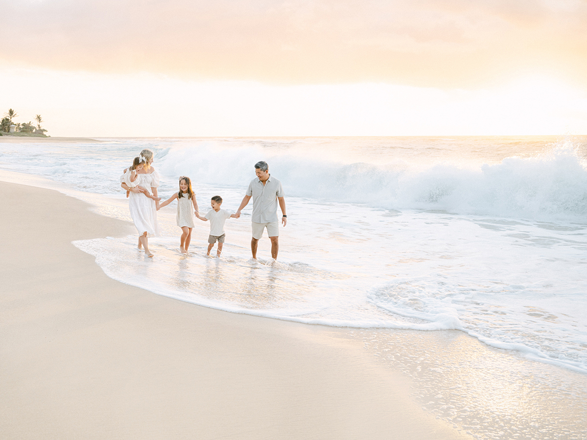 Oahu sunrise family photographer, Laura Ivanova, captures this sweet family on film at Sandy Beach