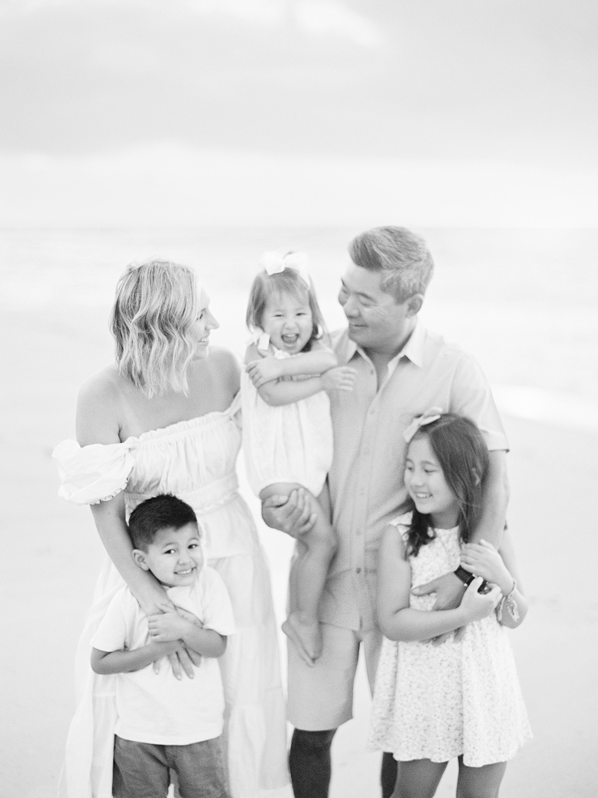 Oahu sunrise family photographer, Laura Ivanova, captures this sweet family on film at Sandy Beach