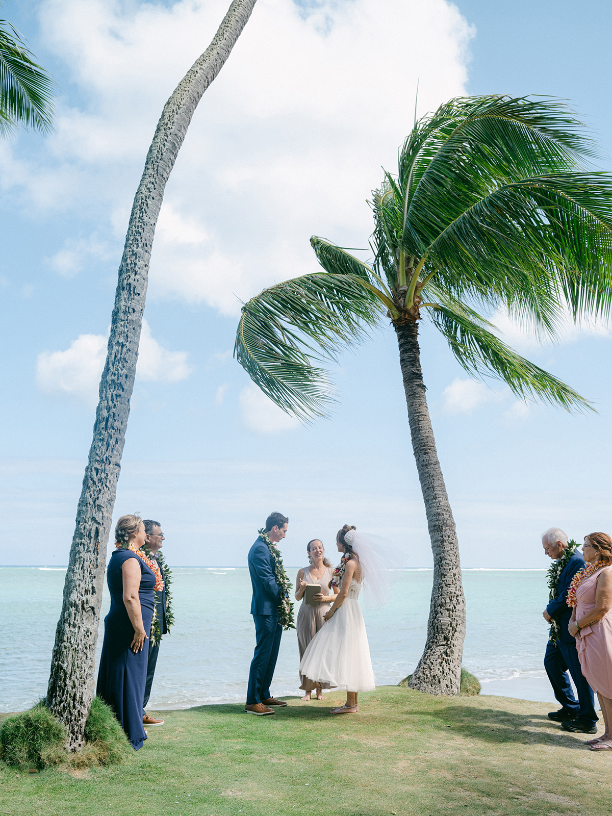 Small wedding ceremony at Waialae Beach on Oahu, Hawaii. Captured by Laura Ivanova Photography