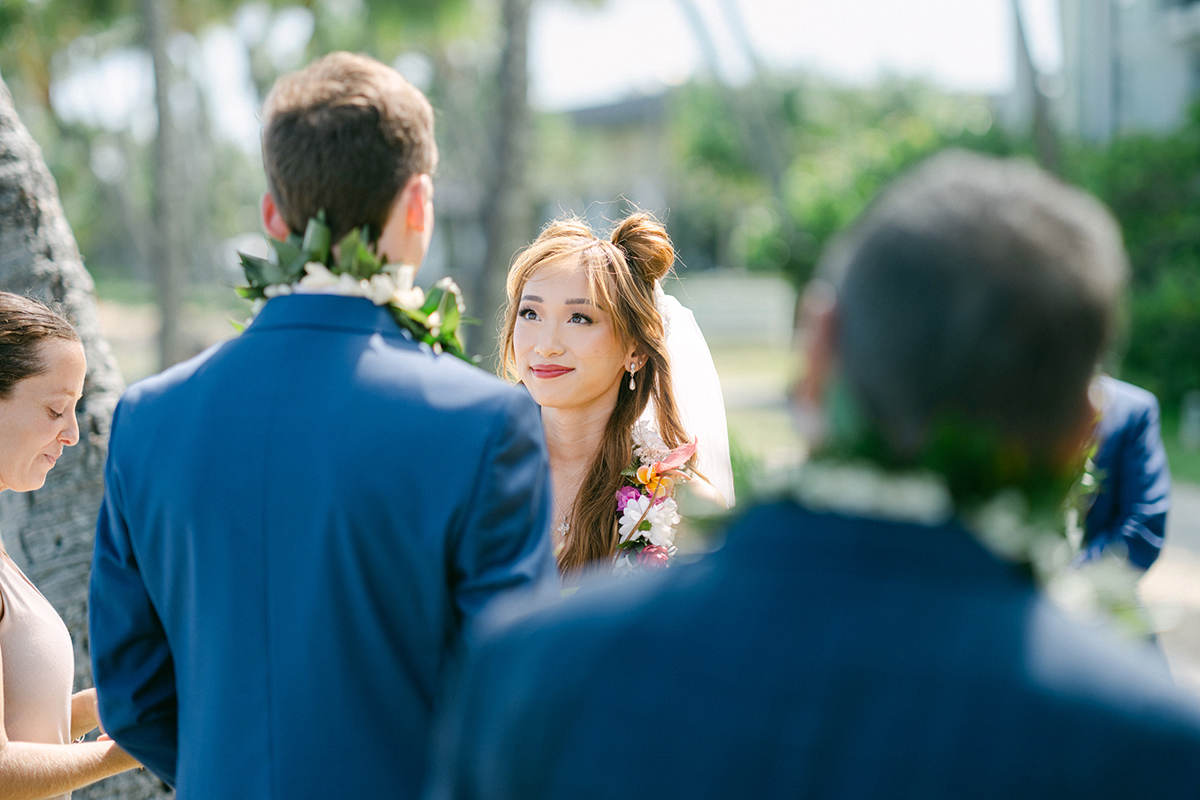 Small wedding ceremony at Waialae Beach on Oahu, Hawaii. Captured by Laura Ivanova Photography