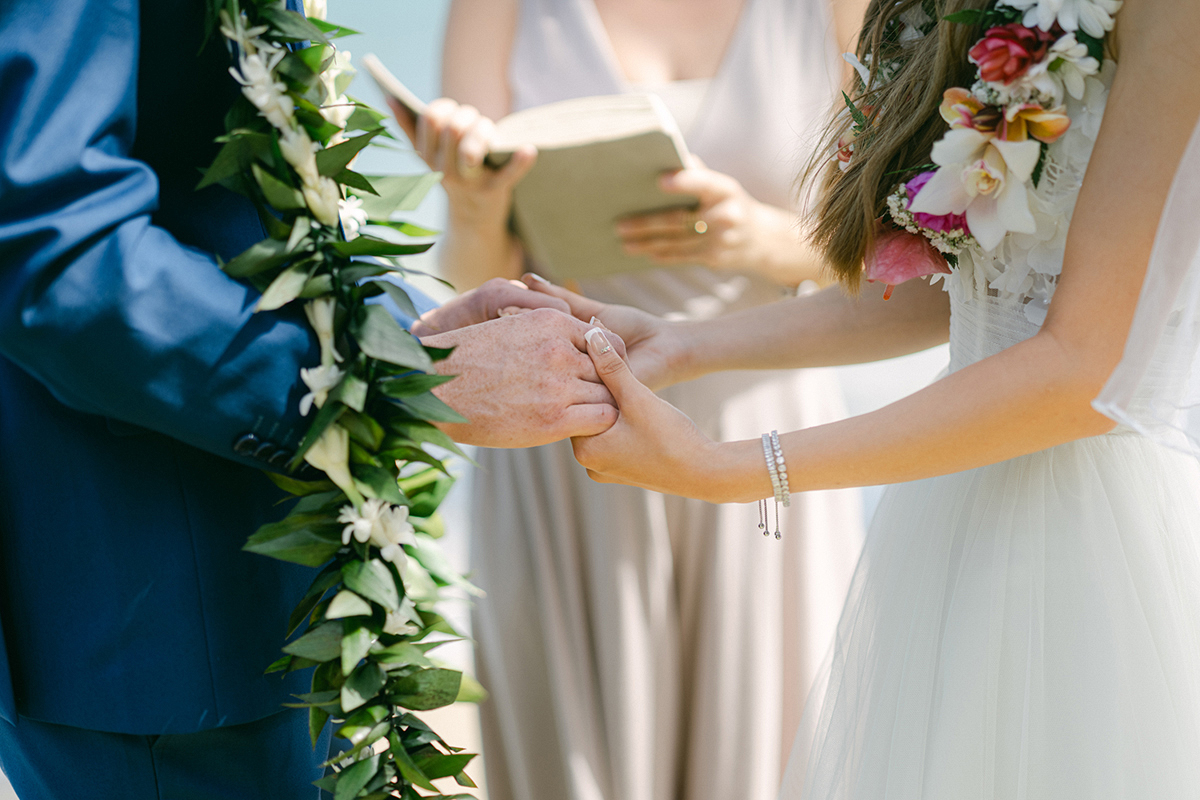 Small wedding ceremony at Waialae Beach on Oahu, Hawaii. Captured by Laura Ivanova Photography