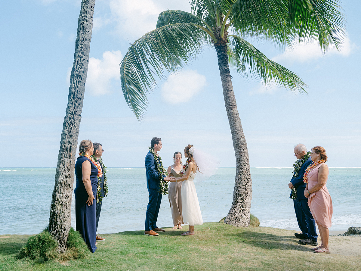 Small wedding ceremony at Waialae Beach on Oahu, Hawaii. Captured by Laura Ivanova Photography