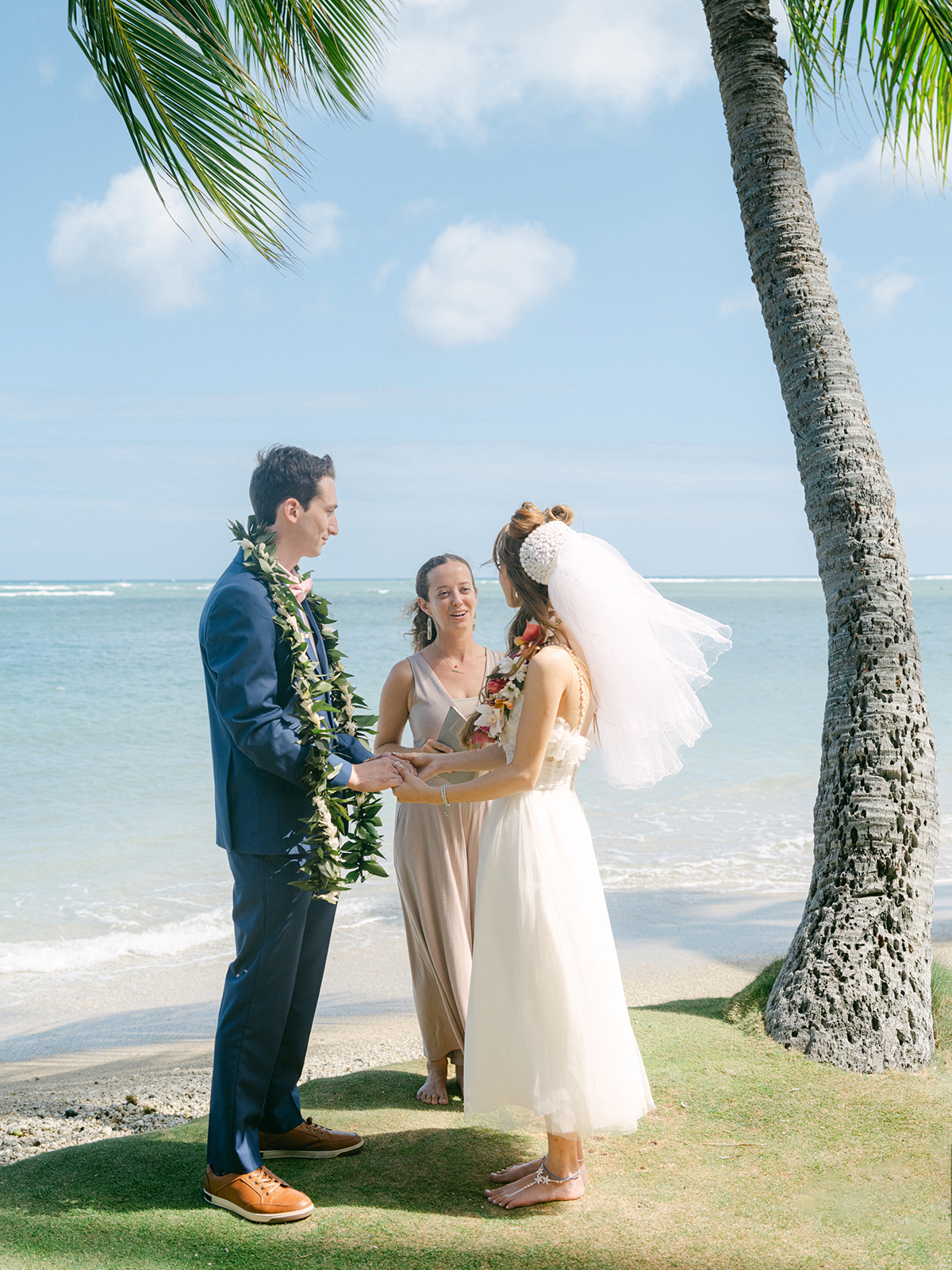 Small wedding ceremony at Waialae Beach on Oahu, Hawaii. Captured by Laura Ivanova Photography