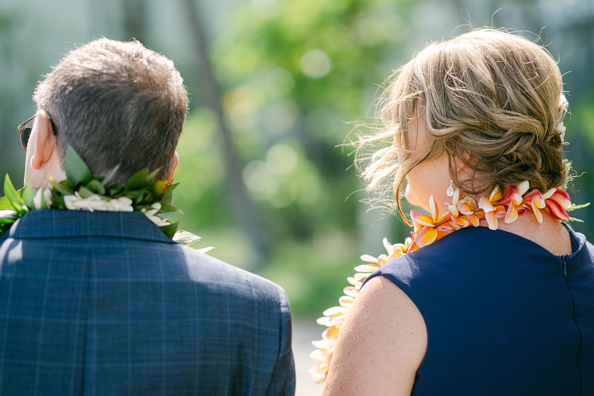 Small wedding ceremony at Waialae Beach on Oahu, Hawaii. Captured by Laura Ivanova Photography