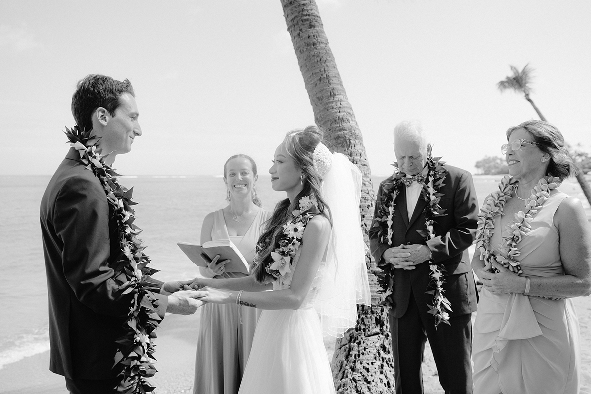 Small wedding ceremony at Waialae Beach on Oahu, Hawaii. Captured by Laura Ivanova Photography