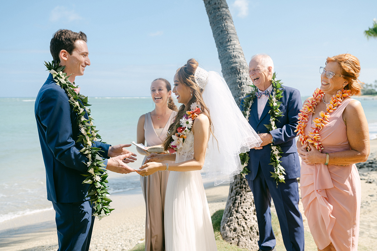 Small wedding ceremony at Waialae Beach on Oahu, Hawaii. Captured by Laura Ivanova Photography