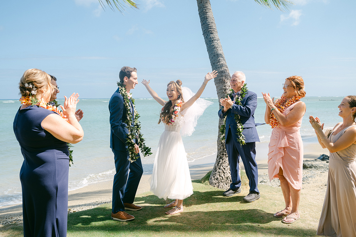 Small wedding ceremony at Waialae Beach on Oahu, Hawaii. Captured by Laura Ivanova Photography