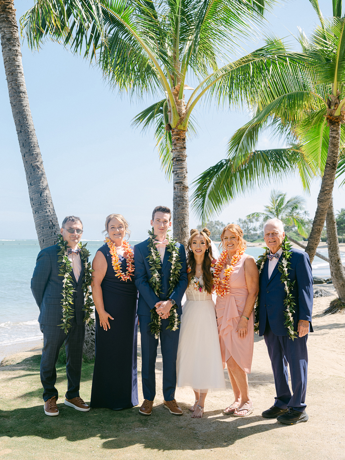 Small wedding ceremony at Waialae Beach on Oahu, Hawaii. Captured by Laura Ivanova Photography