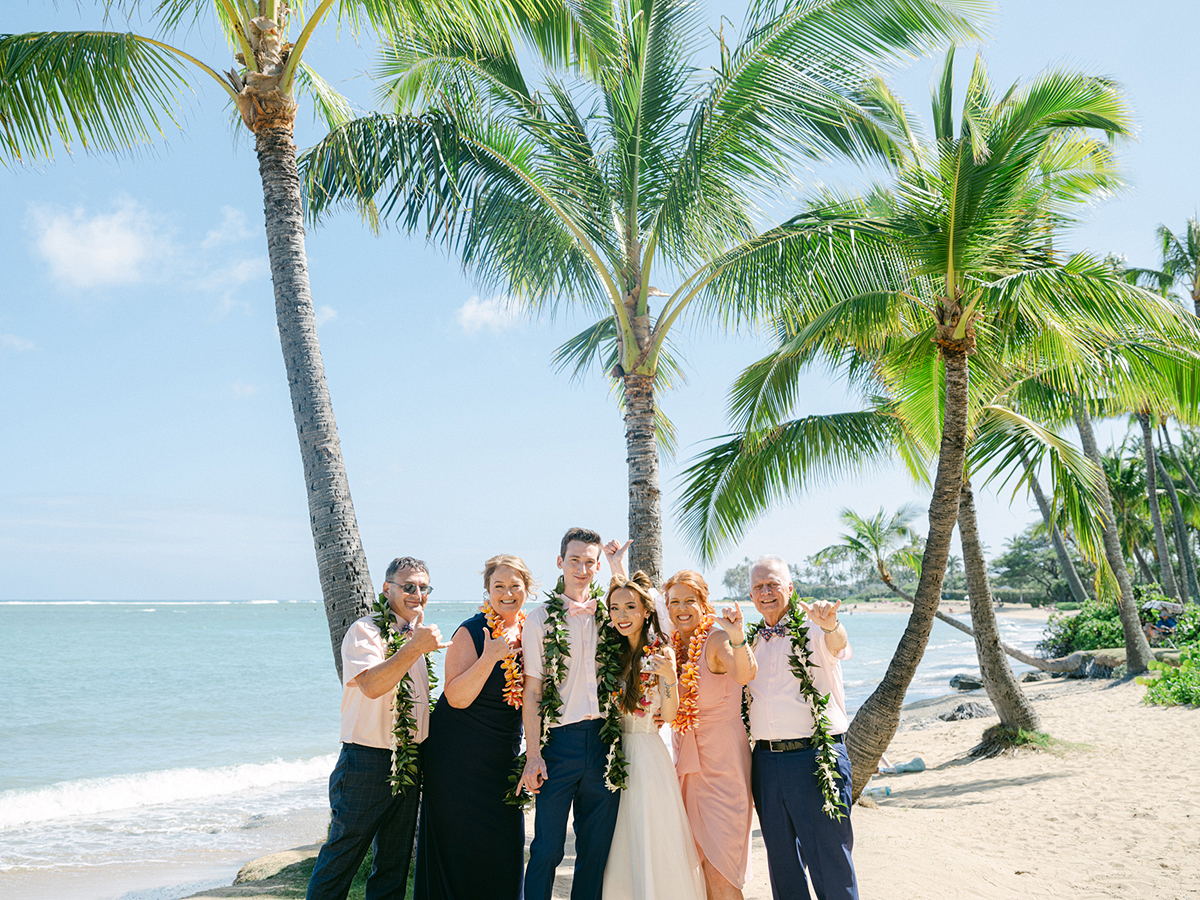 Small wedding ceremony at Waialae Beach on Oahu, Hawaii. Captured by Laura Ivanova Photography