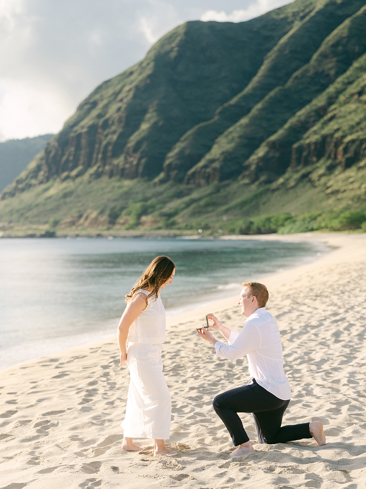 Oahu proposal photographer, Laura Ivanova, captures a surprise sunset proposal in gorgeous Hawaii